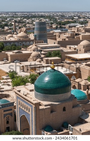 Beautiful aerial view of the 2500-year-old Uzbek city Khiva. Ancient Itchan Kala fortress, Mosque, market and houses in Historic Center of Khiva (UNESCO World Heritage Site), Uzbekistan, Central Asia