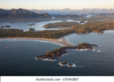 Beautiful aerial view of Chesterman Beach and Frank Island in Tofino, Vancouver Island, British Columbia, Canada. Taken during a sunny summer sunset.