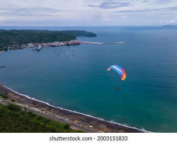 Beautiful aerial view of the extreme sport of paragliding on the Beach and mountains of Costa Rica