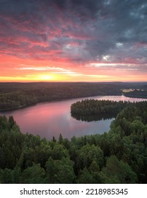 Beautiful aerial view in a Finnish forest landscape with lake and colorful sunset clouds reflection. - Shutterstock ID 2218985345
