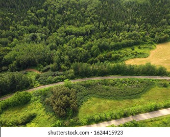 Beautiful Aerial View Of Forested Hill With Train Tracks And Road