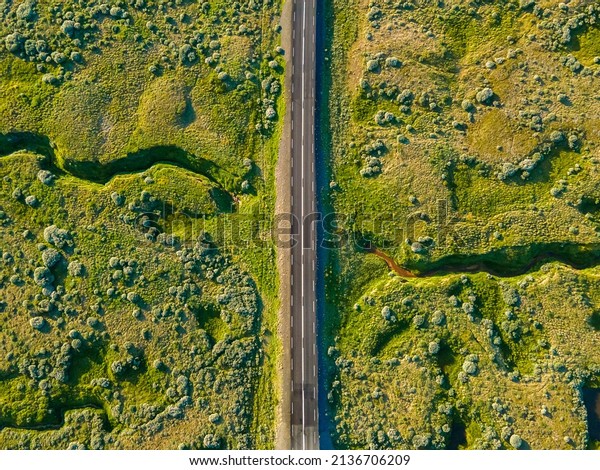 Beautiful aerial view of the\
great lonely highways crossing between mountains and nature, in\
Iceland 