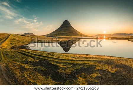 Beautiful aerial view of Kirkjufell volcanic mountain reflect on lake during autumn in the morning at Snaefellsnes peninsula, Iceland