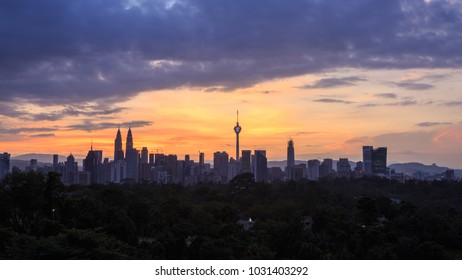 Beautiful Aerial View Of Kuala Lumpur City Skyline, Skyscraper During Sunrise With Dramatic Sky, Clouds And Sun Rays.