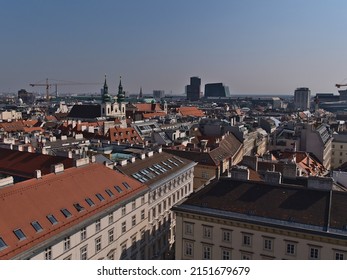 Beautiful aerial view over the historic city center of Vienna, Austria with narrow alley between old buildings and church viewed from Stephansdom cathedral on sunny day in spring. - Shutterstock ID 2151679679