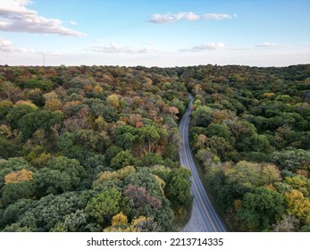 Beautiful Aerial View Of Road Through Forest At Sunset