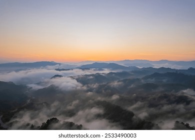 Beautiful aerial view of sunrise over the mountain with fog or clouds. - Powered by Shutterstock