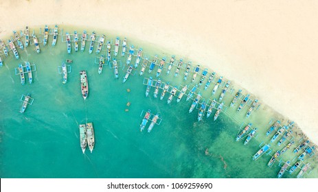 Beautiful aerial view of traditional fisherman boats in a row on the Ujung Genteng beach with turquoise water, Sukabumi, West Java, Indonesia - Powered by Shutterstock