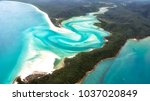A beautiful aerial view of turquoise waters, white sandy beaches and green forests in the paradise of the Whitsunday