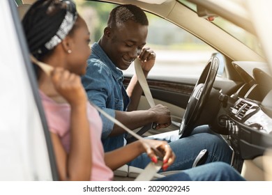 Beautiful African Amerfican Man And Woman Fastening Seat Belts In The Luxury Car, Going Summer Vacation By Automobile, Happy Black Lovers Having Weekend Trip Together, Driving Auto, Copy Space