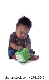 Beautiful African american baby boy playing with a toy on white background