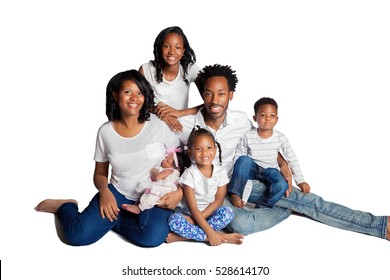 A Beautiful African American Family With Four Young Kids, Pose For A Portrait On A White Backdrop.  Has A Clipping Path Containing The People And Shadows.