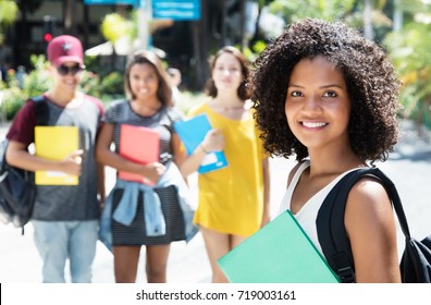 Beautiful African American Female Student With Group Of International Students Outdoor In The City In The Summer