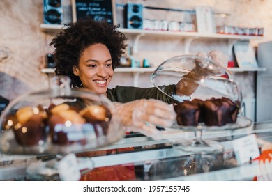 Beautiful African American female worker working in confectionery shop. - Powered by Shutterstock