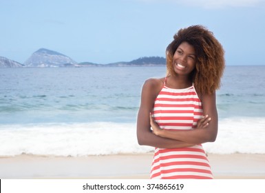 Beautiful African American Girl With Crazy Hairstyle And Striped Dress At Beach