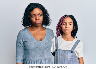 Beautiful African American Mother And Daughter Wearing Casual Clothes And Hugging Depressed And Worry For Distress, Crying Angry And Afraid. Sad Expression. 