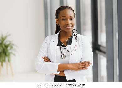 beautiful african american nurse with arms folded - Shutterstock ID 1936087690