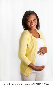 Beautiful African American pregnant woman smiling. 