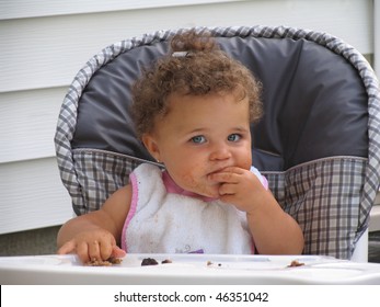 Beautiful African American Toddler Girl Eating Dirty Face;