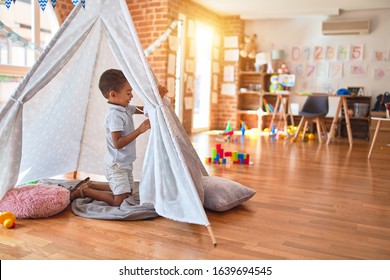 Beautiful African American Toddler Playing Inside Tipi Smiling At Kindergarten