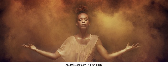 Beautiful african american woman dancer posing over dust. Concept of powerful lady.