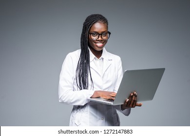 Beautiful African American Woman Doctor Or Nurse Holding A Laptop Computer Isolated On A White Background