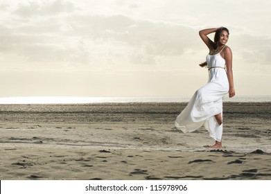 Beautiful African American Woman Doing Dance Pose With A Smile At The Beach.