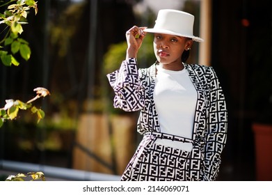 Beautiful African American Woman Natural Makeup Wear Fashion Clothes Casual Black And White Dress Code Office Style Total Blouse And Pants Suit And Hat.