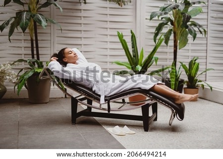 Beautiful African American woman relaxing in welness zone.