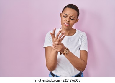 Beautiful African American Woman Standing Over Pink Background Suffering Pain On Hands And Fingers, Arthritis Inflammation 