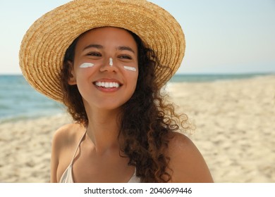 Beautiful African American Woman With Sun Protection Cream On Face At Beach