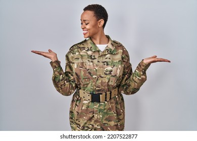 Beautiful african american woman wearing camouflage army uniform smiling showing both hands open palms, presenting and advertising comparison and balance  - Powered by Shutterstock