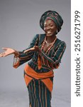 Beautiful African Black woman making hand gestures with facial expressions wearing traditional Nigerian cultural attire