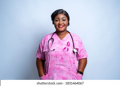 Beautiful African doctor or nurse with stethoscope around neck looking at camera-concept on breast cancer awareness campaign - Powered by Shutterstock