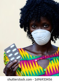 Beautiful African Doctor Woman Holding Pills And Wearing Mask Against Virus