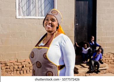 Beautiful African Family Outside Their House In The Township With The Mother In Focus.