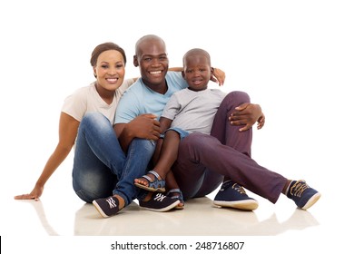 beautiful african family sitting on the floor isolated on white