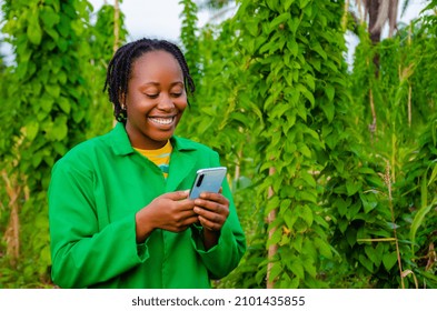 beautiful african farmer happy with the news she saw on her phone - Powered by Shutterstock