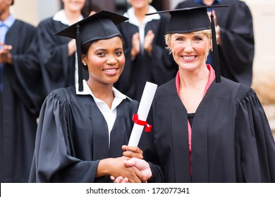 Beautiful African Female Graduate Handshaking With Dean Outside University