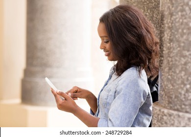 Beautiful African University Student Texting On Smart Phone