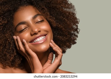 Beautiful african woman black t-shirt portrait afro haircut touching her face Color background green - Shutterstock ID 2083213294