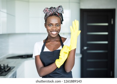 beautiful african woman cleaning cupboard - Powered by Shutterstock