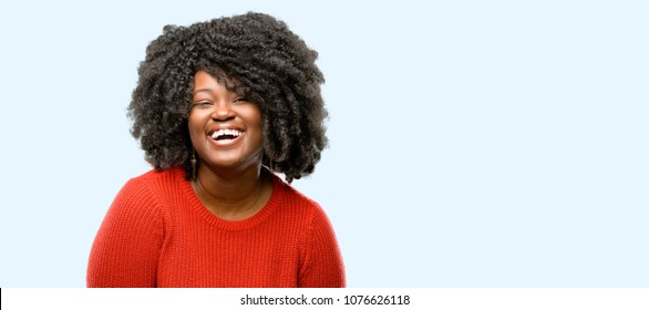 Beautiful African Woman Confident And Happy With A Big Natural Smile Laughing, Blue Background