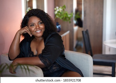 beautiful african woman enjoy sitting on armchair, have rest at home. leisure time - Powered by Shutterstock