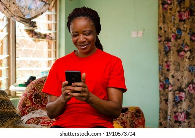 beautiful african woman gets excited about what saw on her cellphone