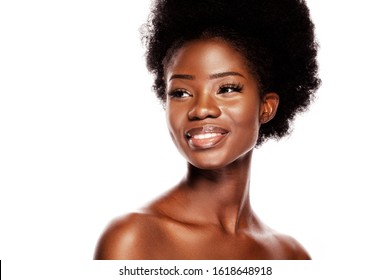 Beautiful African Woman with a Happy Smile. Youngl Black Model With White Teeth and Healthy Skin Looks to the Sideaway. Isolated on White Background in Beauty Skin Concept.