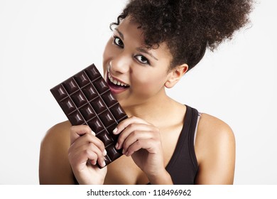 Beautiful African Woman Holding And Eating A Huge Dark Chocolate Bar