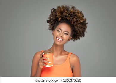 Beautiful african woman laughing and looking at camera with joy.  Beauty afro american girl with curly hair smiling. - Powered by Shutterstock