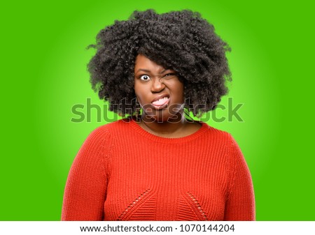 Beautiful african woman making funny face fooling