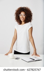 Beautiful African Young Woman Entrepreneur Smiling Looking At Camera Standing Near New Workplace. Future Graphic Designer.